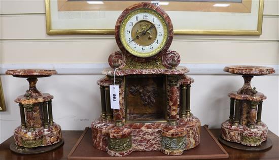 A 19th century French rouge marble three piece clock garniture, height 47cm
